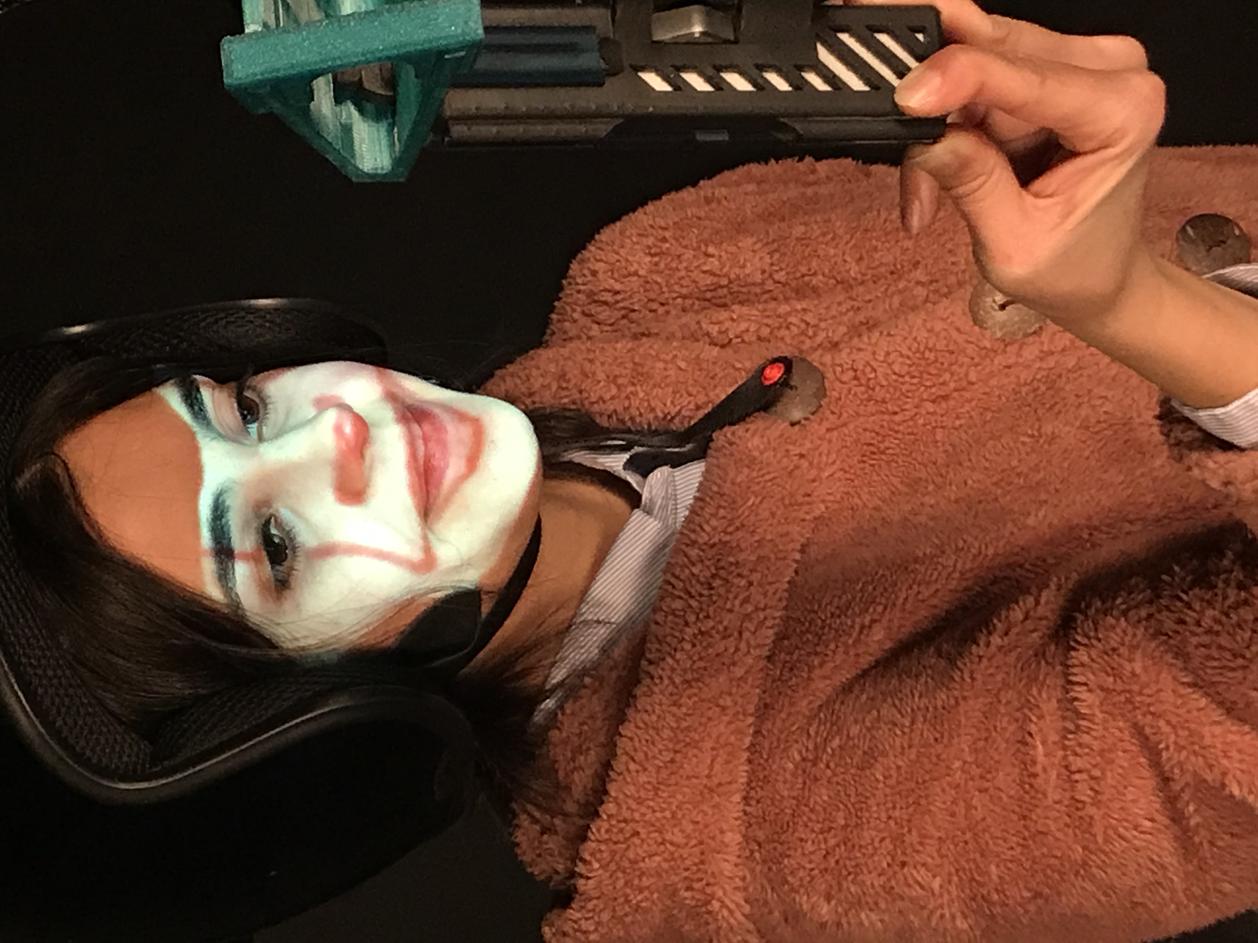 A UK student in SAVS demonstrating the digital face paint system with the face of Penny Wise from Stephen King's IT, tracking facial expressions in real time