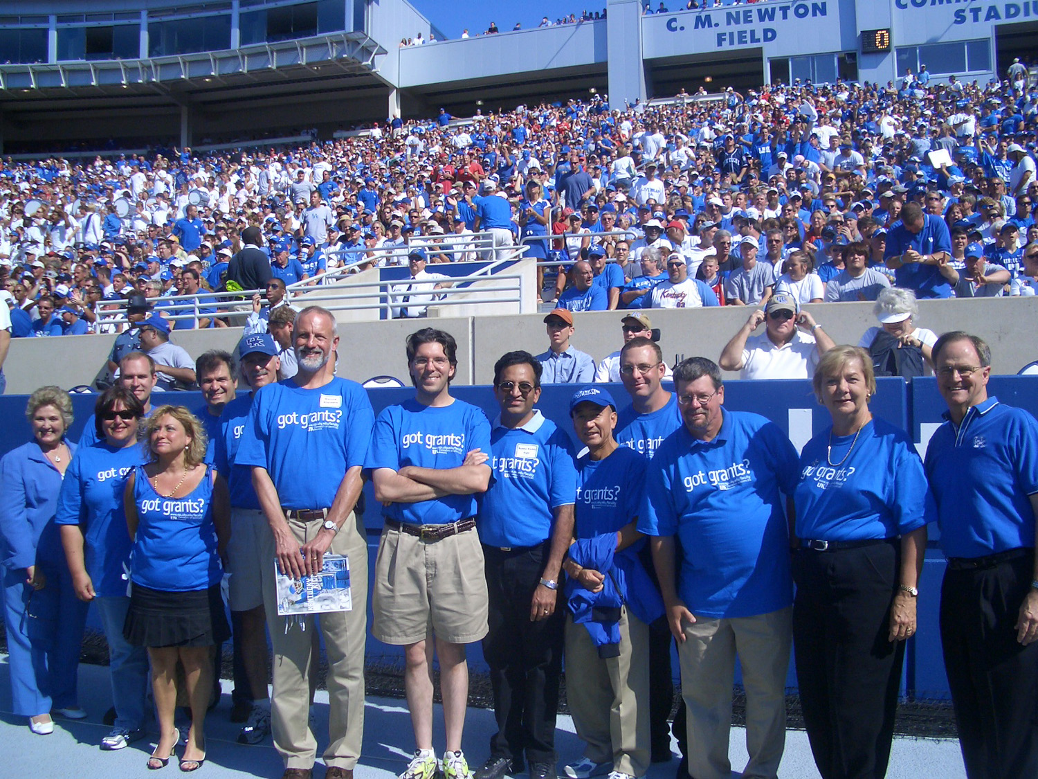Dr. Lau at a UK football game being honored for research funding achievements during halftime along with other UK faculty